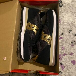 Brand new still in box black and gold Saucony sneakers. Women’s size 11